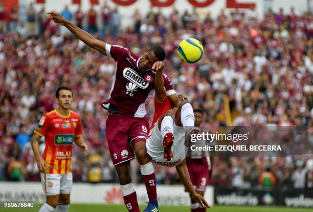 Deportivo Saprissa player Jerry Bengtson goes for the ball with Junior Diaz of Club Sport Herediano during the Costa Rica Football Championship...