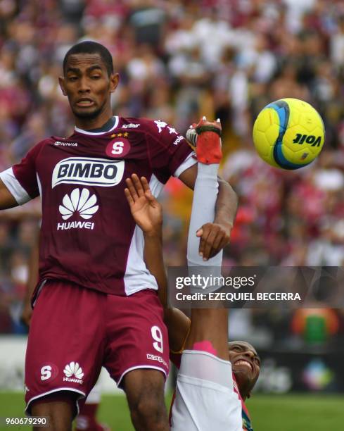 Deportivo Saprissa player Jerry Bengtson vies for the ball with Junior Diaz of Club Sport Herediano during the Costa Rica Football Championship...