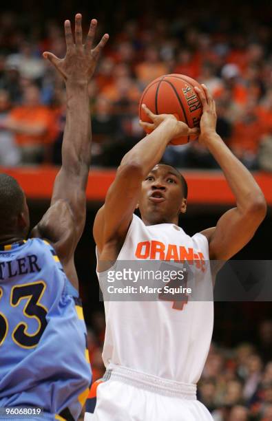 Wesley Johnson of the Syracuse Orange shoots the ball as Jimmy Butler of the Marquette Golden Eagles attempts to block it during the game at Carrier...
