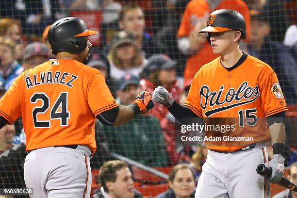 Pedro Alvarez high fives Chance Sisco of the Baltimore Orioles after hitting a two-run home run in the sixth inning of a game against the Boston Red...