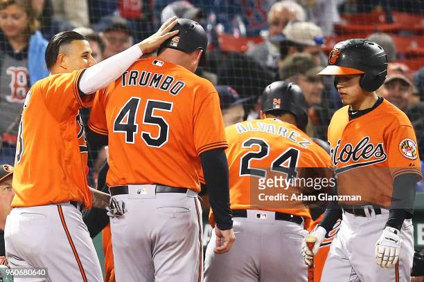 Manny Machado embraces Mark Trumbo after Pedro Alvarez of the Baltimore Orioles hits a two-run home run in the fifth inning of a game against the...