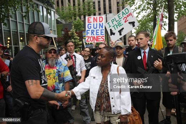 Joey Gibson, leader of the Patriot Prayer group, speaks with Bridgette Jones from Seattle, during a march advocating the right to openly carry guns...