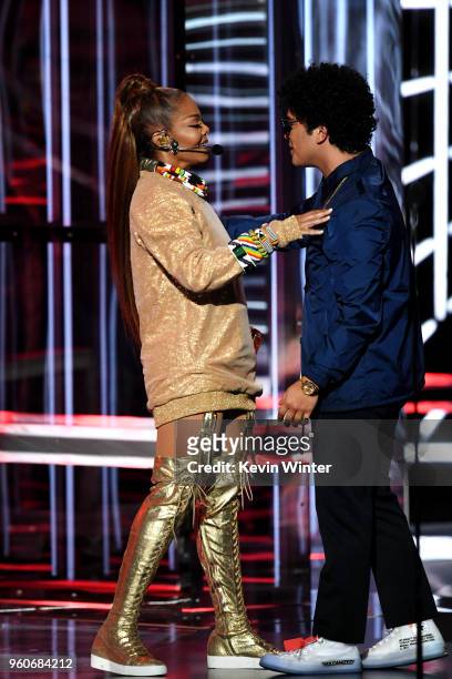 Honoree Janet Jackson accepts the Icon Award from recording artist Bruno Mars onstage during the 2018 Billboard Music Awards at MGM Grand Garden...