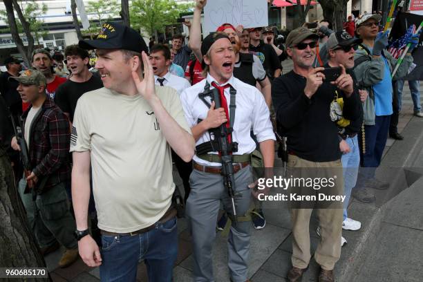 Jonathan Ames and other gun rights advocates shout "U.S.A." at protesters across the street during an Open Carry rally on May 20, 2018 in Seattle,...