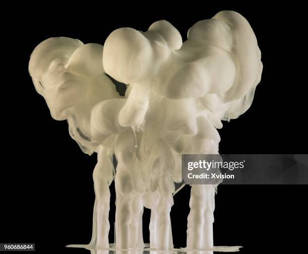 white color splash into water with black background - blender explosion stock pictures, royalty-free photos & images