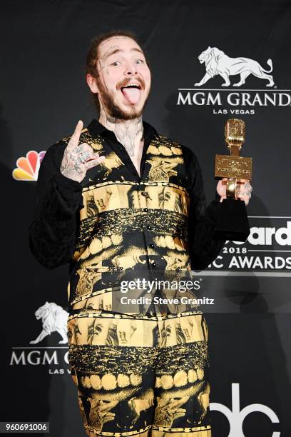 Recording artist Post Malone, winner of the Top Rap Song award for 'Rockstar,' poses in the press room during the 2018 Billboard Music Awards at MGM...