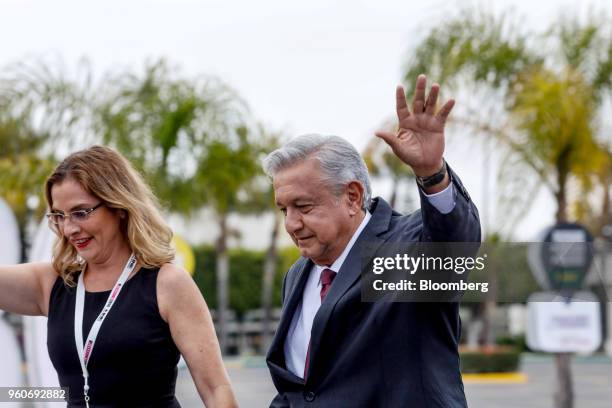 Andres Manuel Lopez Obrador, presidential candidate of the National Regeneration Movement Party , right, waves as he arrives with his wife Beatriz...