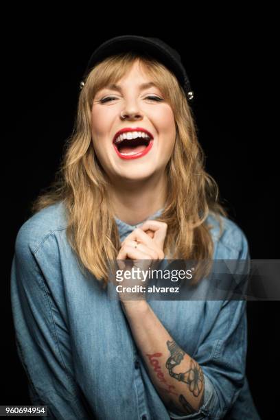 beautiful woman laughing against black background - blonde hair black background stock pictures, royalty-free photos & images
