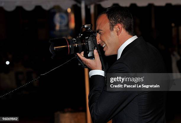 Presenter Nikos Aliagas takes a picture as he arrives at Palais des Festivals to attend NRJ Music Awards on January 23, 2010 in Cannes, France.