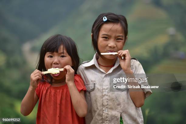 stand on the street with ice cream in hand. in vietnam - girl with glass of milk bildbanksfoton och bilder