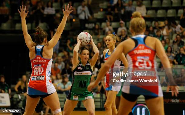 Ingrid Colyer of the West Coast Fever looks to pass the ball through the players during the round four Super Netball match between the Fever and the...