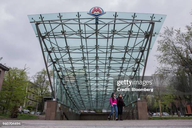 Pedestrians exit an Almaty Metro station in Almaty, Kazakhstan, on Thursday, April 26, 2018. By juggling its reserves to reduce the pain of negative...