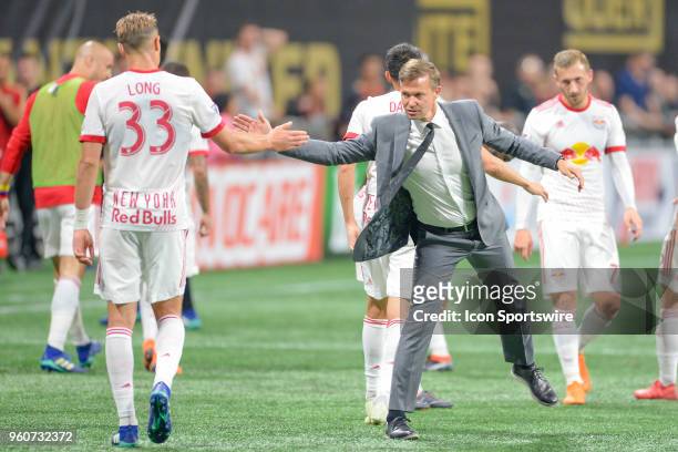 New York head coach Jesse Marsch shakes hands with Aaron Long at halftime during the match between Atlanta United and New York Red Bulls on May 20,...