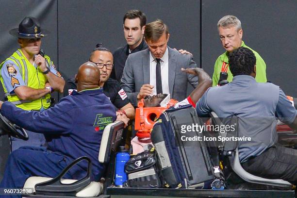 New York head coach Jesse Marsch talks to injured player Kemar Lawrence as he is carried off the pitch after sustaining an injury during the match...