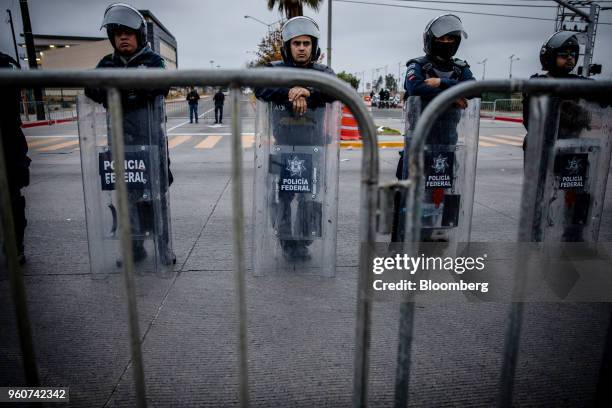 Police officers in riot gear stand behind barricades outside the venue of the second presidential debate in Tijuana, Mexico, on Sunday, May 20, 2018....