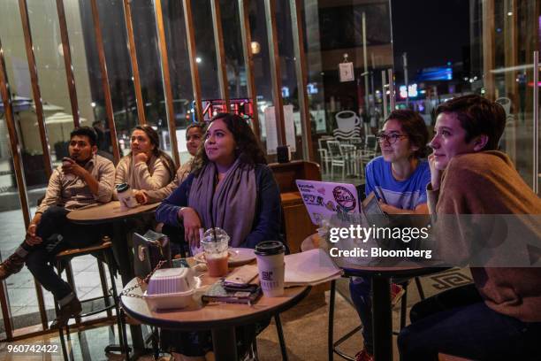 Customers watch a broadcast of the second presidential debate inside a restaurant in Tijuana, Mexico, on Sunday, May 20, 2018. While the peso has...