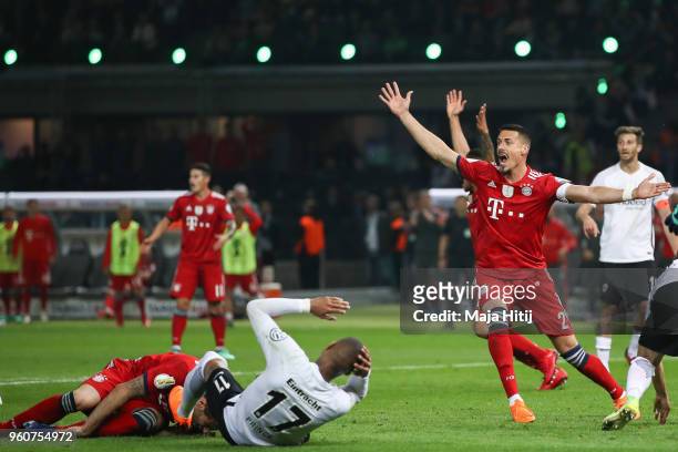 Sandro Wagner of FC Bayern Muenchen reacts as Javi Martinez of FC Bayern Muenchen and by Kevin-Prince Boateng of Eintracht Frankfurt lay on the pitch...