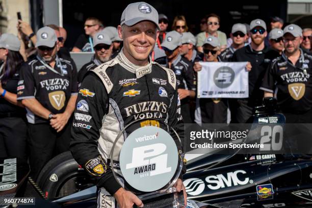 Ed Carpenter, driver of the Ed Carpenter Racing Chevrolet, holds a Verizon P1 award and poses for photos after recording the fastest time to qualify...