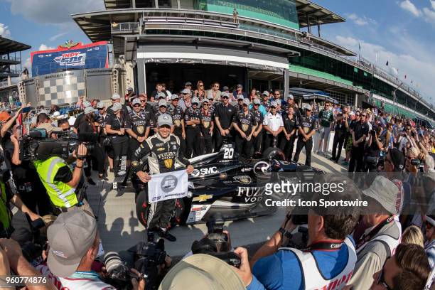 Ed Carpenter, driver of the Ed Carpenter Racing Chevrolet, holds a P1 banner and poses for photos after recording the fastest time to qualify for...