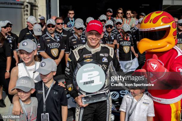 Ed Carpenter, driver of the Ed Carpenter Racing Chevrolet, holds a Verizon P1 award and poses for photos with his children after recording the...
