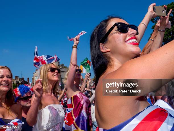 Well-wishers attend the wedding of Prince Harry to Ms. Meghan Markle at Windsor Castle on May 19, 2018 in Windsor, England. Prince Henry Charles...
