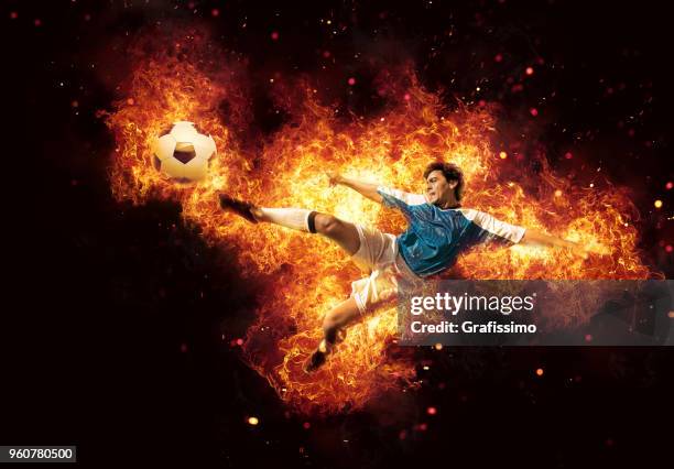 best soccer player kicking ball surrounded by fire and flames - hot latin nights stock pictures, royalty-free photos & images