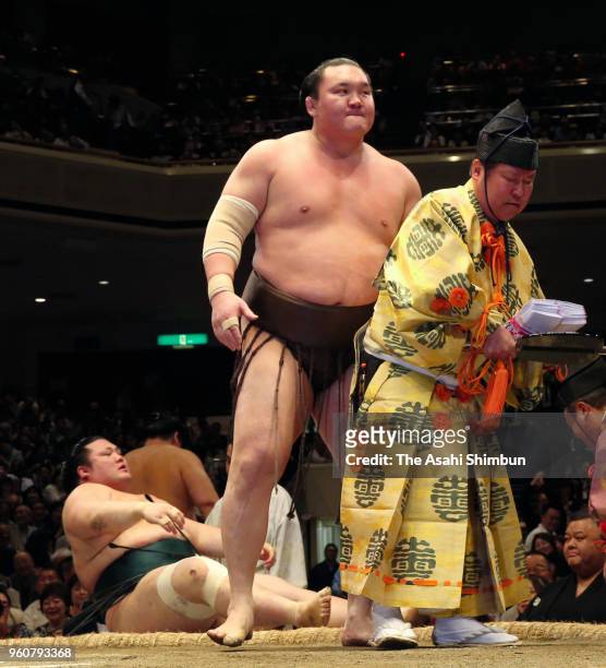 Mongolian yokozuna Hakuho reacts after his victory over Yutakayama on day eight of the Grand Sumo Summer Tournament at Ryogoku Kokugikan on May 20,...