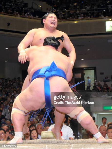 Kotoshogiku pushes Abi out of the ring to win on day eight of the Grand Sumo Summer Tournament at Ryogoku Kokugikan on May 20, 2018 in Tokyo, Japan.