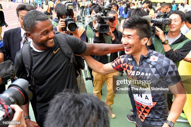 Justin Gatlin of the United States and Yoshihide Kiryu of Japan embrace after the Mern's 4x100m Relay during the Seiko Golden Grand Prix at Yanmar...