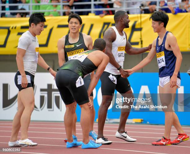 Justin Gatlin of the United States shakes hands with Japanese sprinters after the Men's 100m during the Seiko Golden Grand Prix at Yanmar Stadium...