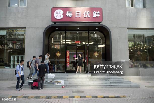 Pedestrians walk past a Miss Fresh office in Beijing, China, on Wednesday, May 9, 2018. Tencent-backed Mr. Fresh, a spinoff of better-established...