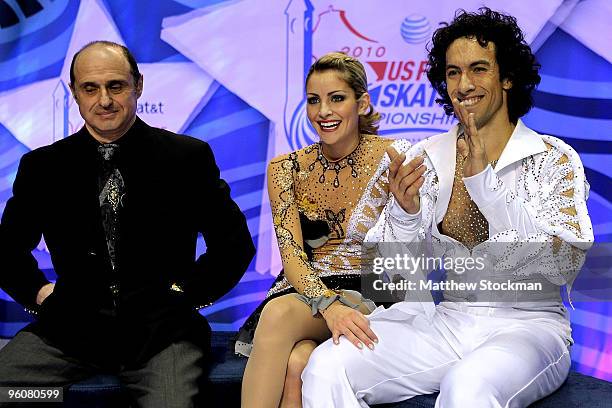 Tanith Belbin and Benjamin Agosto watch their scores from the kiss and cry with their coach Gennadi Karpanosov after the free dance competition...