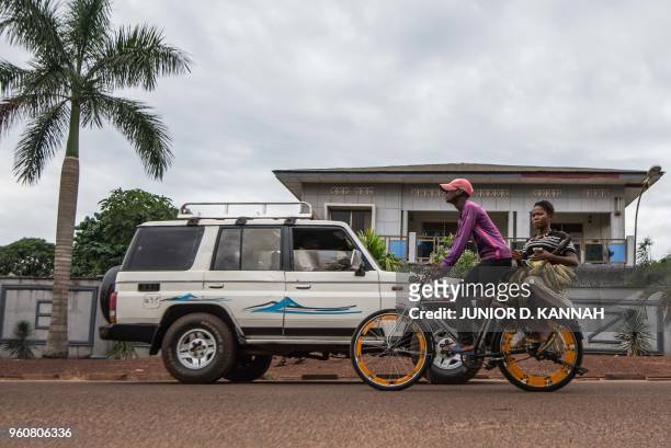 Bike taxi carries a woman on May 20, 2018 on Bonsomi avenue in Mbandaka, northwest of DR Congo as 45 cases of Ebola virus has been recorded in the...