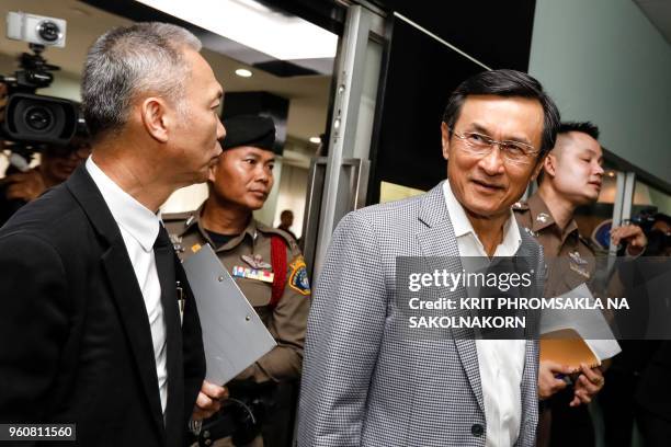 Pheu Thai party leader Chaudron Chaisang leaves the crime suppression division after being charged with sedition in Bangkok on May 21, 2018. - Three...