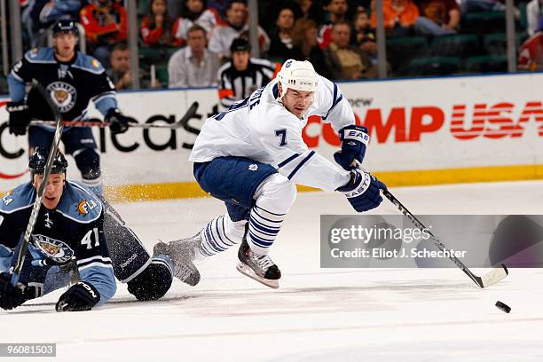 Ian White of the Toronto Maple Leafs battles for the puck against Shawn Matthias of the Florida Panthers at the BankAtlantic Center on January 23,...