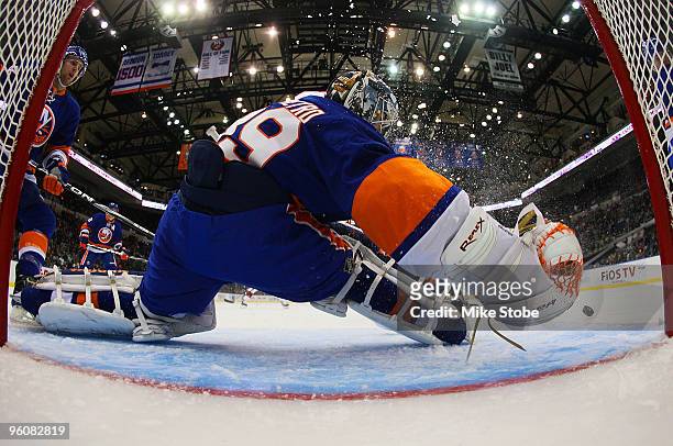 Goaltender Rick DiPietro of the New York Islanders makes a save against the New Jersey Devils on January 23, 2010 at Nassau Coliseum in Uniondale,...