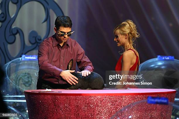 Candidate Hubert Bucher performs with a rabbit beside of host Michelle Hunziker during the Wetten dass...? TV Show on January 23, 2010 in...