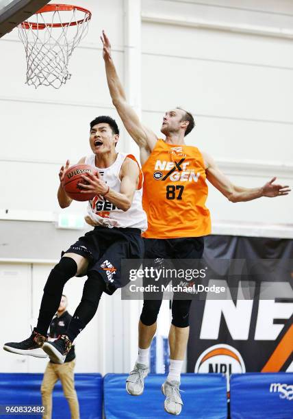 Zhang ZiYi of Perth drives hard to the hoop against Lucas Thomas of Melbourne at the Melbourne Sports and Aquatic Centre on May 21, 2018 in...