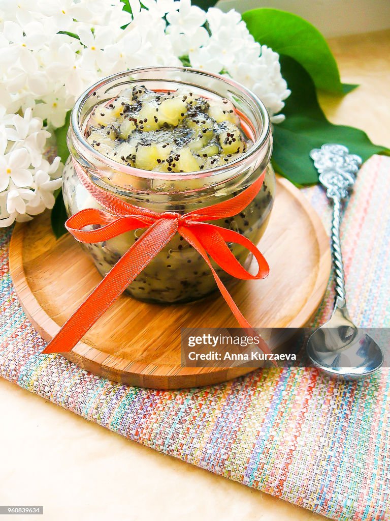 Pear jam or marmalade with poppy seeds in a jar, selective focus. Dessert food. Preserved food.