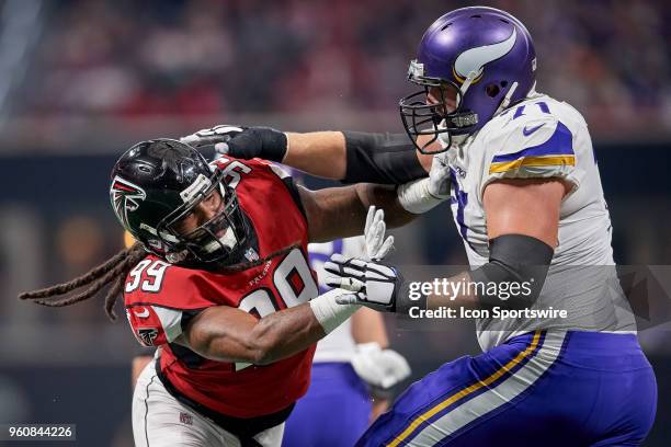 Atlanta Falcons defensive tackle Jon Cunningham \battles with Minnesota Vikings offensive tackle Riley Reiff during an NFL football game between the...