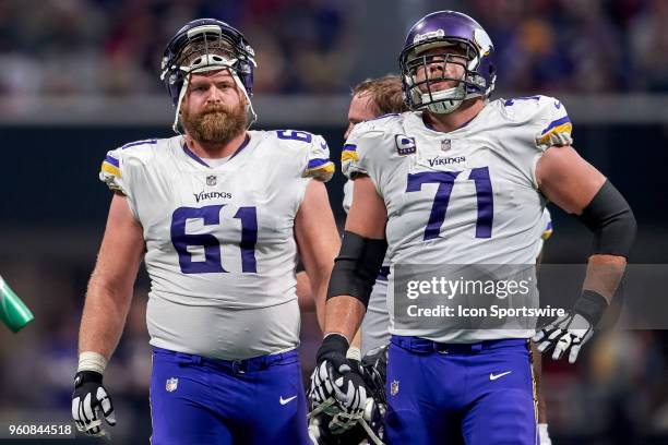 Minnesota Vikings defensive end Ade Aruna and Minnesota Vikings offensive tackle Riley Reiff look on during an NFL football game between the...