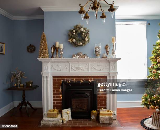 christmas tree by fireplace with decoration at home - mantelpiece stock pictures, royalty-free photos & images