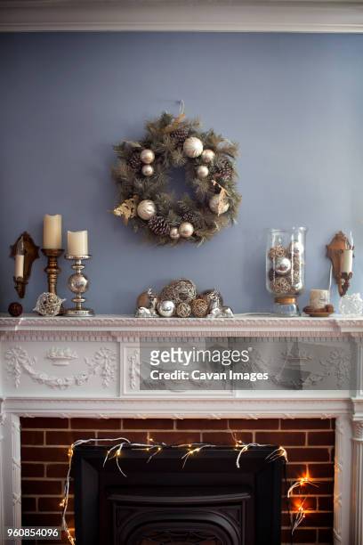christmas wreaths hanging on wall over fireplace - mantel stock pictures, royalty-free photos & images