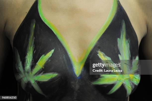 Female who has Cannabis leaf painted on her body at the Indica Sativa Trade at Unipol Arena on May 20, 2018 in Bologna, Italy. The 6th Italian...