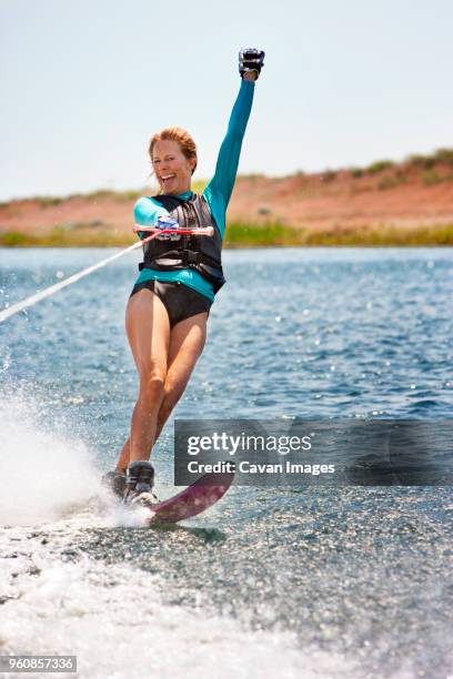 cheerful woman wakeboarding in sea - waterskiing stock pictures, royalty-free photos & images
