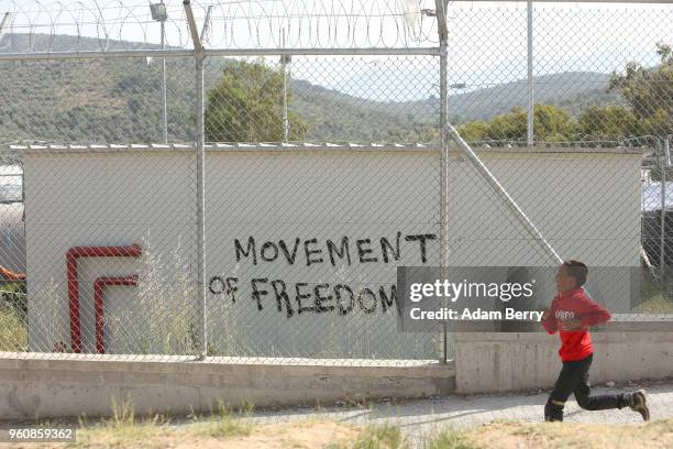 Child runs at the Moria refugee camp on May 20, 2018 in Mytilene, Greece. Despite being built to hold only 2,500 people, the camp on the Greek island...