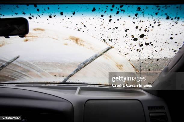 Wiper Moving On Dirty Windshield Seen Through Car High-Res Stock
