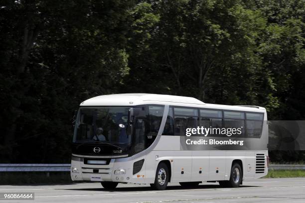 Hino Motors Ltd. Bus travels along a road during a demonstration at a test course in Hamura, Tokyo Metropolis, Japan, on Monday, May 21, 2018. The...