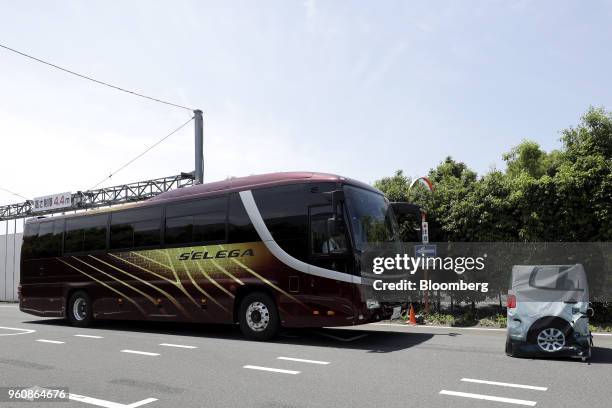 Hino Motors Ltd. Tour bus stops autonomously in front of an obstacle during a demonstration at a test course in Hamura, Tokyo Metropolis, Japan, on...