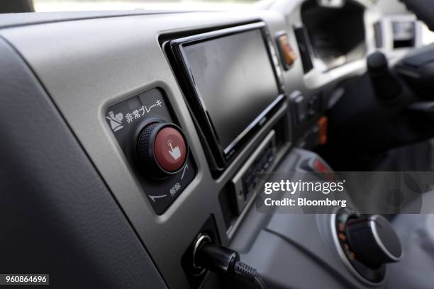 Button to trigger an automated emergency stop is seen onboard a Hino Motors Ltd. Bus during a demonstration at a test course in Hamura, Tokyo...
